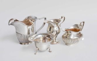Four Assorted Silver Cream-Jugs, variously formed, most in the George III style, 16.5cm wide over
