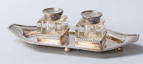 An Edward VII Silver Inkstand, by Henry Wigfull, Sheffield, 1904, oblong and on four bun feet,