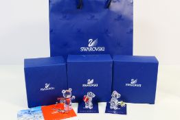 Swarovski - Three boxed Kris Bear ornaments, the first with skis,