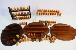 A collection of treen thimbles including Mauchline Ware style examples with decoration of religious