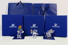 Three boxed Swarovski Kris Bear ornaments to include one holding a flower,
