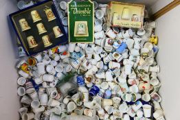 A large quantity of collector thimbles, predominantly ceramic, various makers.