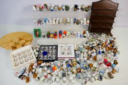 A large quantity of collector thimbles to include treen, glass, ceramic, cloisonne and similar,