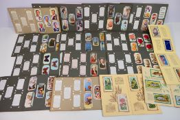 A collection of cigarette cards, organised into sets and housed in albums to include Ogdens, Wills,