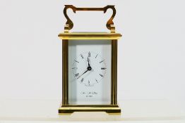 A brass and five glass carriage clock, Roman numerals to a white dial signed for William Widdop,