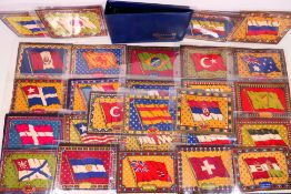 A binder of cigarette felts / blankets, all decorated with flags, approximately 15 cm x 21 cm,