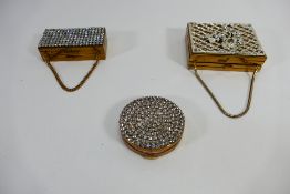 A lady's vintage combination compact / cigarette case with chain suspension,