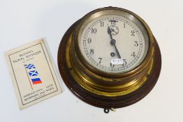 A vintage brass cased bulkhead clock, Arabic numerals and subsidiary seconds dial, 14 cm (d) dial,