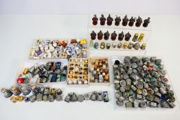 A collection of thimbles to include pewter, treen, brass, cloisonne and other.