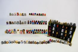 A collection of thimbles comprising cloisonne, white metal, mother of pearl mounted and other.