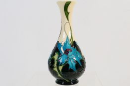 Moorcroft - A Moorcroft Pottery vase with slender neck decorated in the Sea Holly pattern,