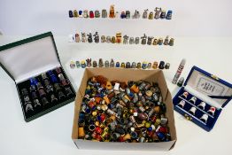 A good collection of thimbles comprising metal, treen, cloisonne and other.