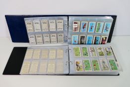 Two binders of cigarette and similar cards comprising Ogden's, Player's, Will's,