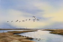 Jonathan Yule (Norfolk School) - A watercolour coastal landscape scene, wild geese over an estuary,
