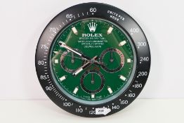 A clock / watch dealers advertising display wall clock, green dial with three subsidiary dials, 33.