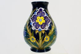Moorcroft - A Moorcroft Pottery vase decorated in the Florian Daisy pattern with purple,
