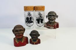 Three vintage money banks, two cast iron