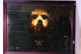 A large framed movie poster for Friday T