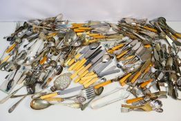 A large collection of mixed flatware.