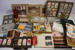 A mixed lot to include cigarette cards, stamps, postcards and similar.