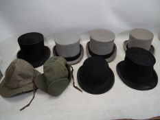 A collection of vintage hats, predominan