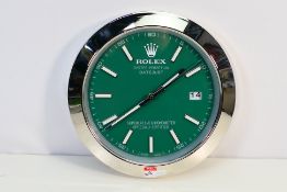 A clock / watch dealers advertising display wall clock, green dial with date at 3 o'clock, 33.