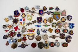 A collection of enamel pin badges and similar.