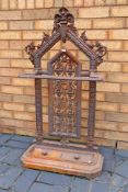 A cast iron umbrella / stick stand with decoration of oak leaves and vines,