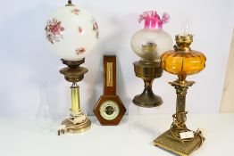 Three oil/style lamps, two of which are