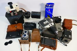 A collection of vintage cameras to include Polaroid, Olympus and other.
