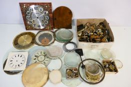A box of clock and watch parts to include dials, glass, movements and other.