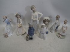 A collection of ceramic figures. Tallest