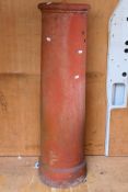 A tall terracotta chimney pot. [W]