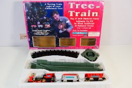 Tree Train - A boxed battery operated 36 inch diameter Christmas Tree Train.