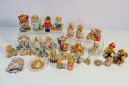 A collection of Cherished Teddies ornamental figures / groups.