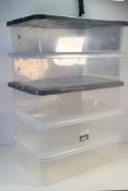 Five clear plastic storage boxes approxi