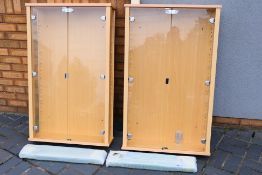 A pair of twin door glazed display cabin