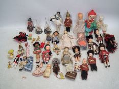 Dolls - a mixed collection of various sized, dolls in plastic cases, an accessories,