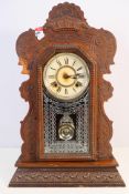 An Ansonia Clock Co shelf clock with carved decoration to the case, approximately 57 cm (h),