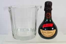 A Moet & Chandon Petite Liquorelle ice bucket and a 200 ml bottle of Petite Liquorelle, 18% abv.