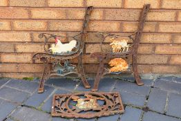 A pair of cast metal bench ends with ani