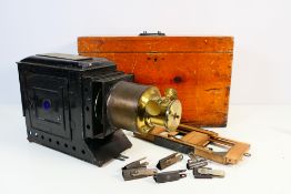A vintage brass mounted magic lantern projector, contained in wooden case.