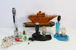 A collection of vintage table lamps to include a wooden ship form example,