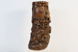 A Chinese bamboo carving with a figure sleeping below pine trees, approximately 31 cm (h).