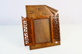 A good quality wooden, easel back photograph frame with fretwork cover and decorated with swallows,