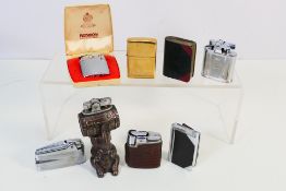 Lighters - Eight vintage lighters to include a barrel balancing elephant lighter two 