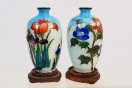 A pair of Japanese cloisonne vases with floral decoration against a light blue ground, unsigned,