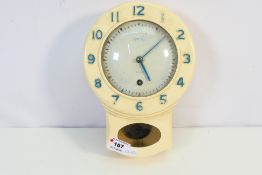 A cream Bakelite cased Smiths drop dial wall clock, with pendulum.