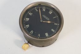 A vintage Jaeger dashboard clock, Roman numerals to a signed black dial, 8.5 cm (d).