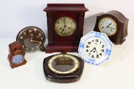 A collection of vintage mantel and wall clocks.